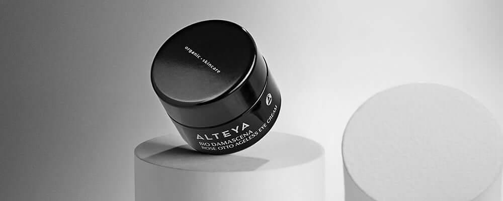 A jar of ayria cream sitting on top of a white pedestal.
