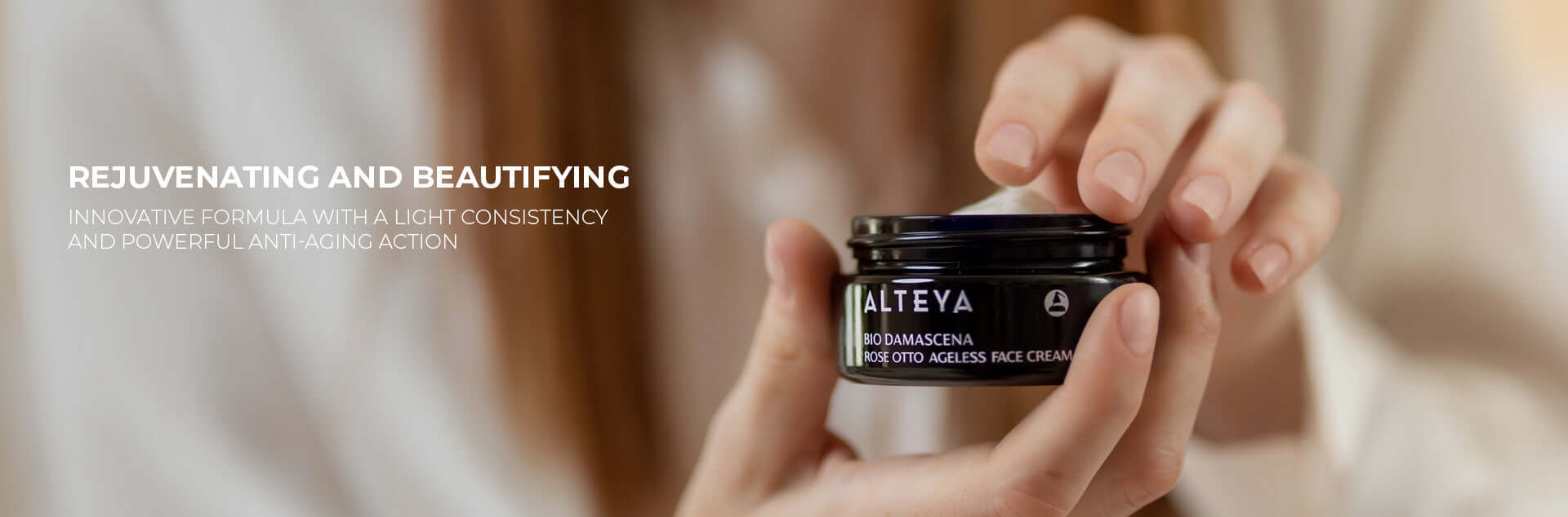 A woman is holding a jar of a cream.