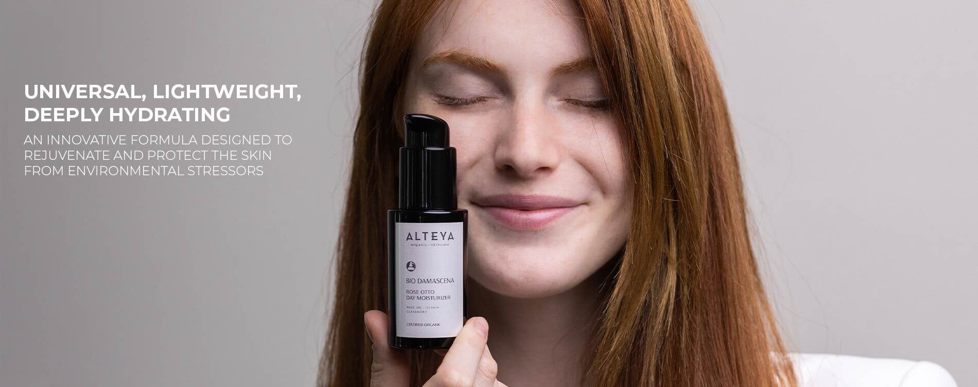 A woman is holding a bottle of a lightening serum.