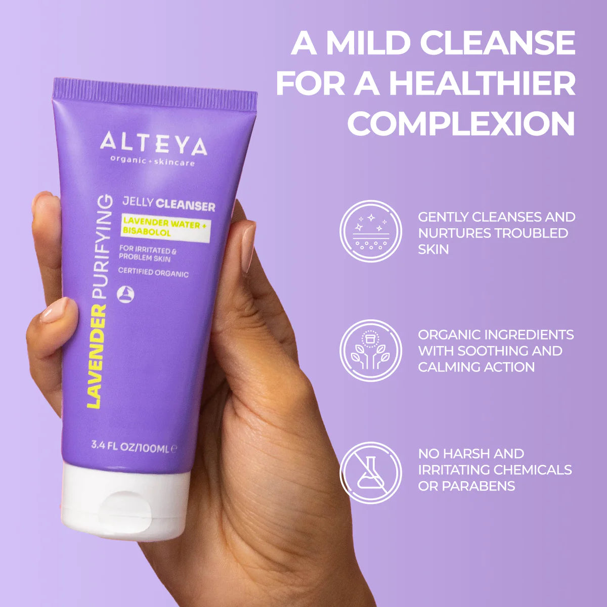 A hand holding a bottle of Alteya Organics' Lavender Purifying Jelly Cleanser for a healthier complexion.