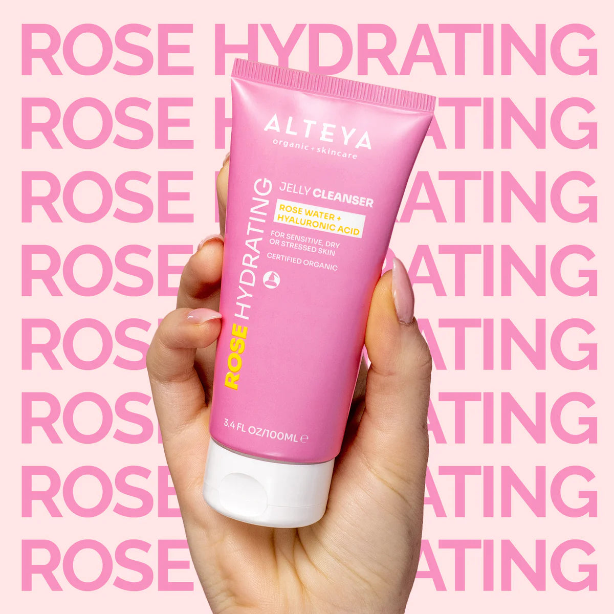 A woman holding a tube of Alteya Organics Rose Hydrating Jelly Cleanser.