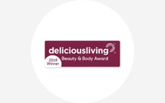 A logo for the delicious living beauty & body award.