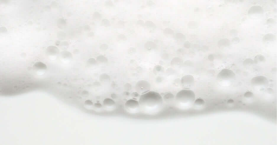 A close up of white foam on a white background.