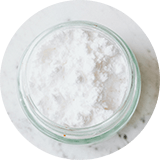 White powder in a jar on a marble table.