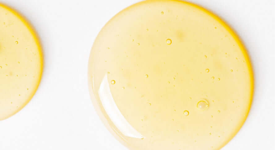 Two yellow circles on a white surface.