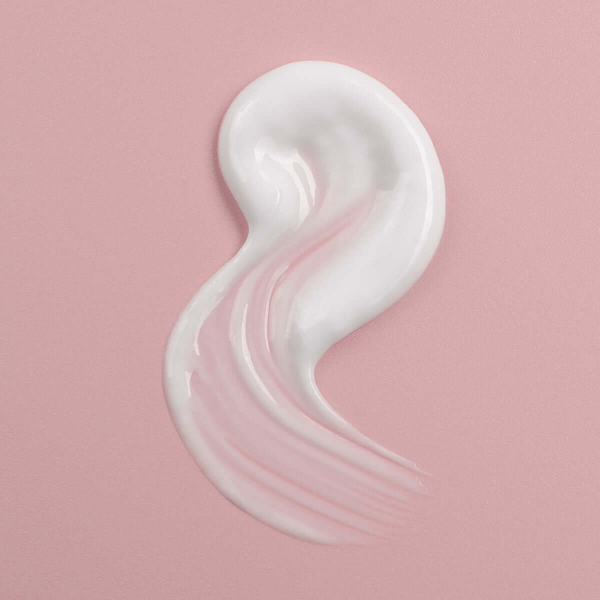 An Alteya Organics Bio Damascena Rose Otto Cleansing Milk with a white cream on a pink background.