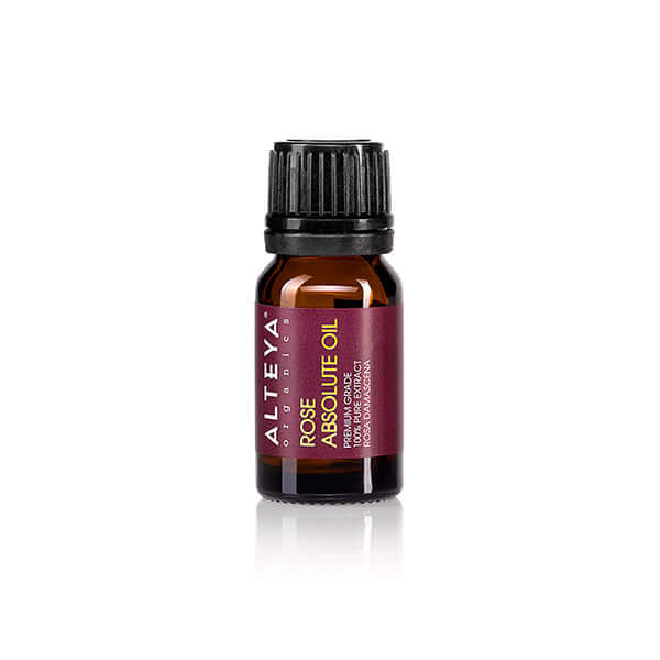 An intense floral aroma emanates from this bottle of Alteya Organics Bulgarian Rose Absolute, against a white background.