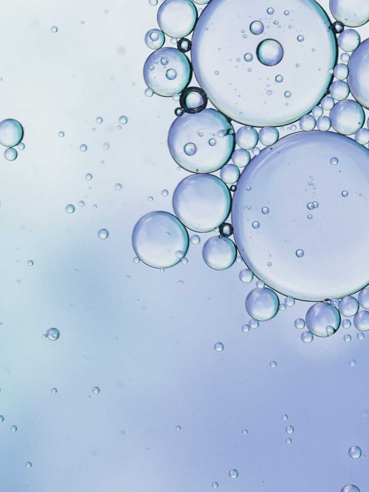 A close up of water bubbles on a blue background.
