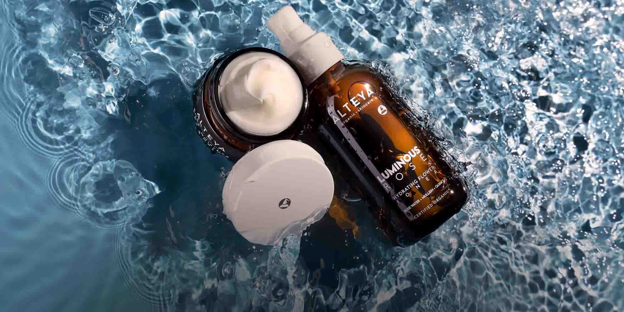 A bottle of cream and a bottle of water on the surface of the water.