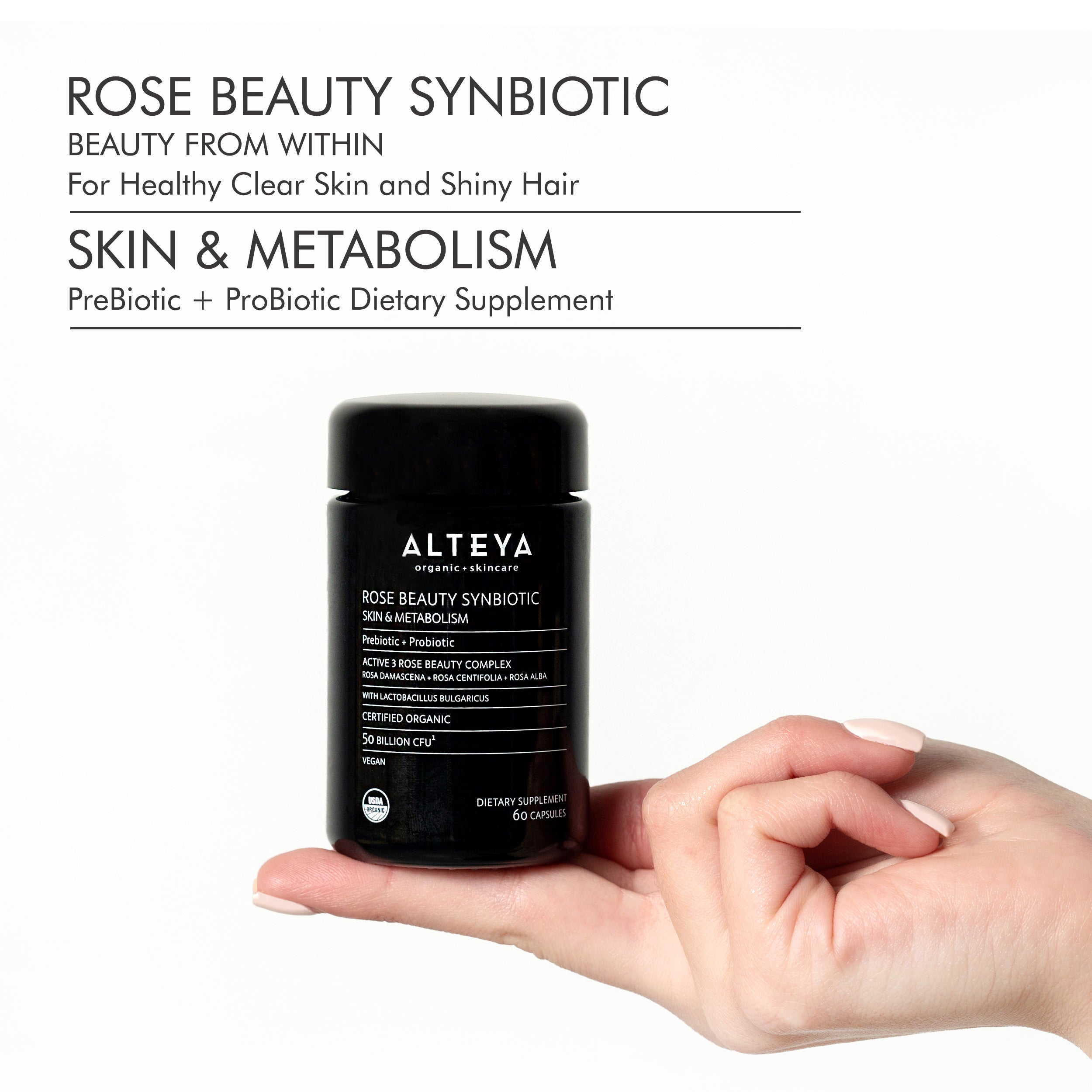 A hand holding a bottle of Alteya Organics Rose Beauty Prebiotic and Probiotic - Synbiotic Skin & Metabolism Vegan Organic Supplement, promoting gut health with its probiotic properties.