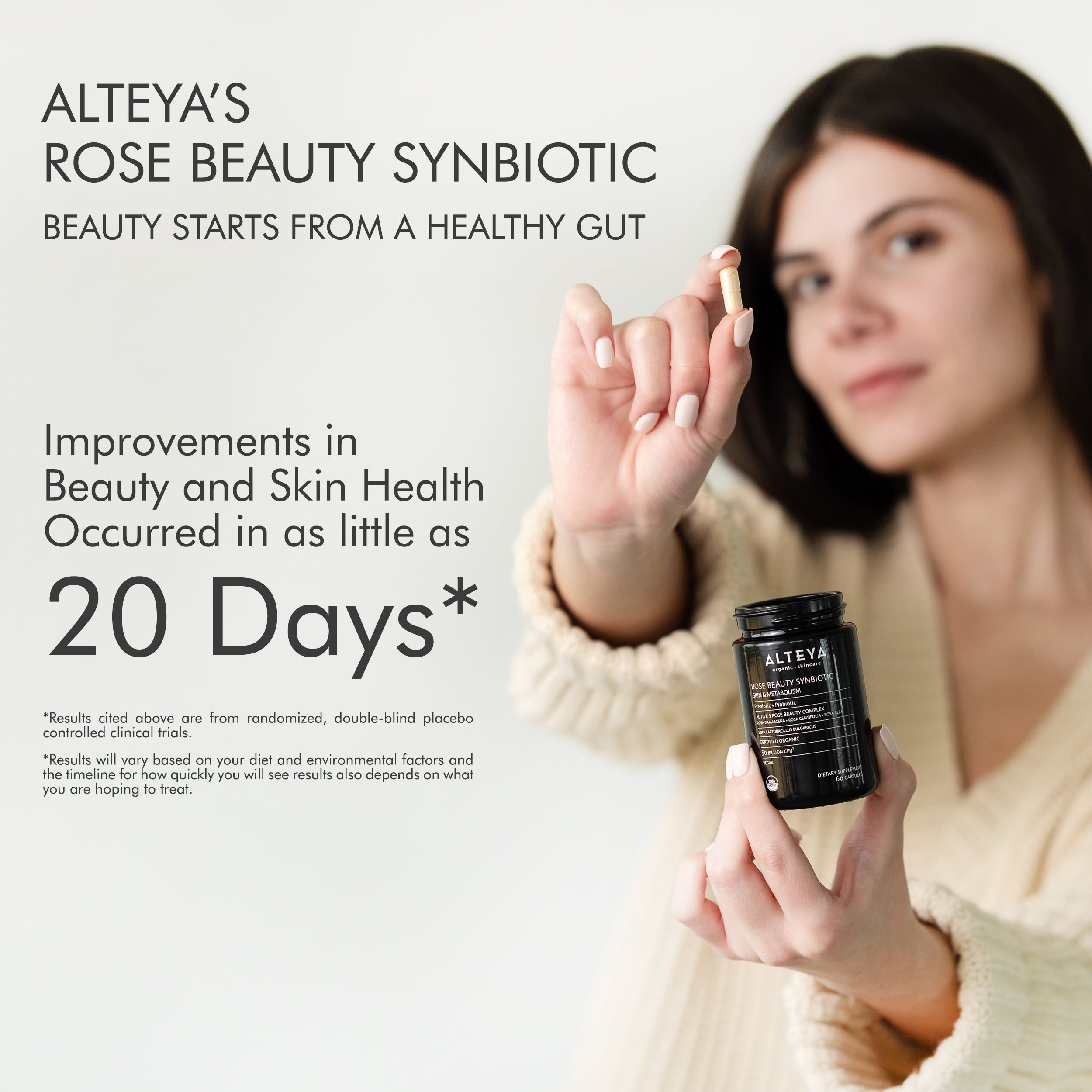 A woman holding a bottle of Alteya Organics' Rose Beauty Prebiotic and Probiotic - Synbiotic Skin & Metabolism Vegan Organic Supplement, promoting gut health.