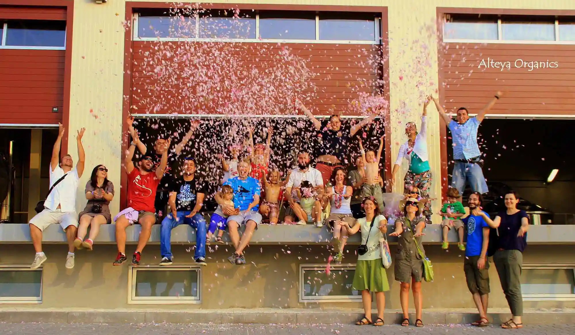 A group of people posing in front of a building.