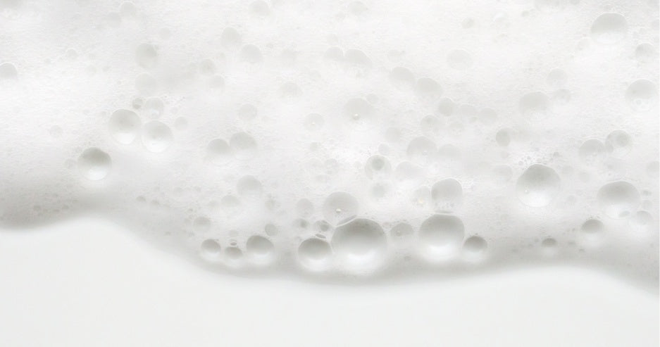 A close up of white foam on a white background.