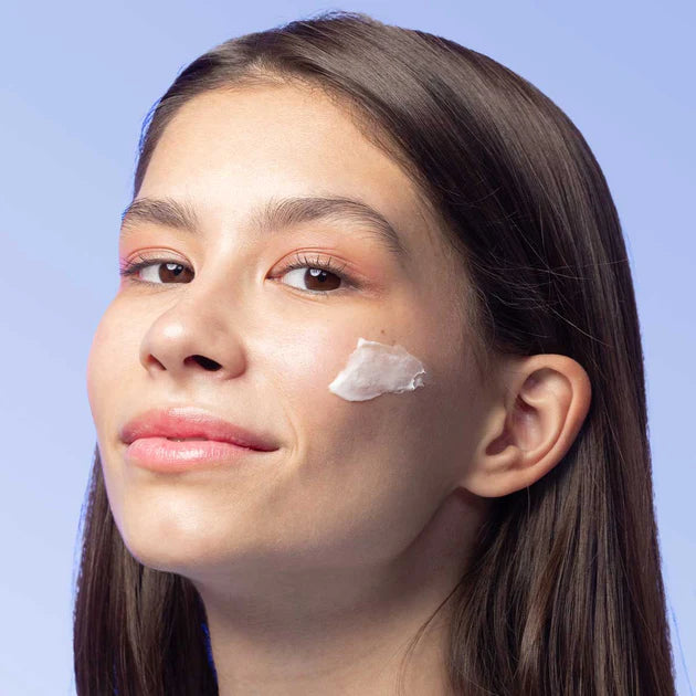 A woman with a cream on her face.