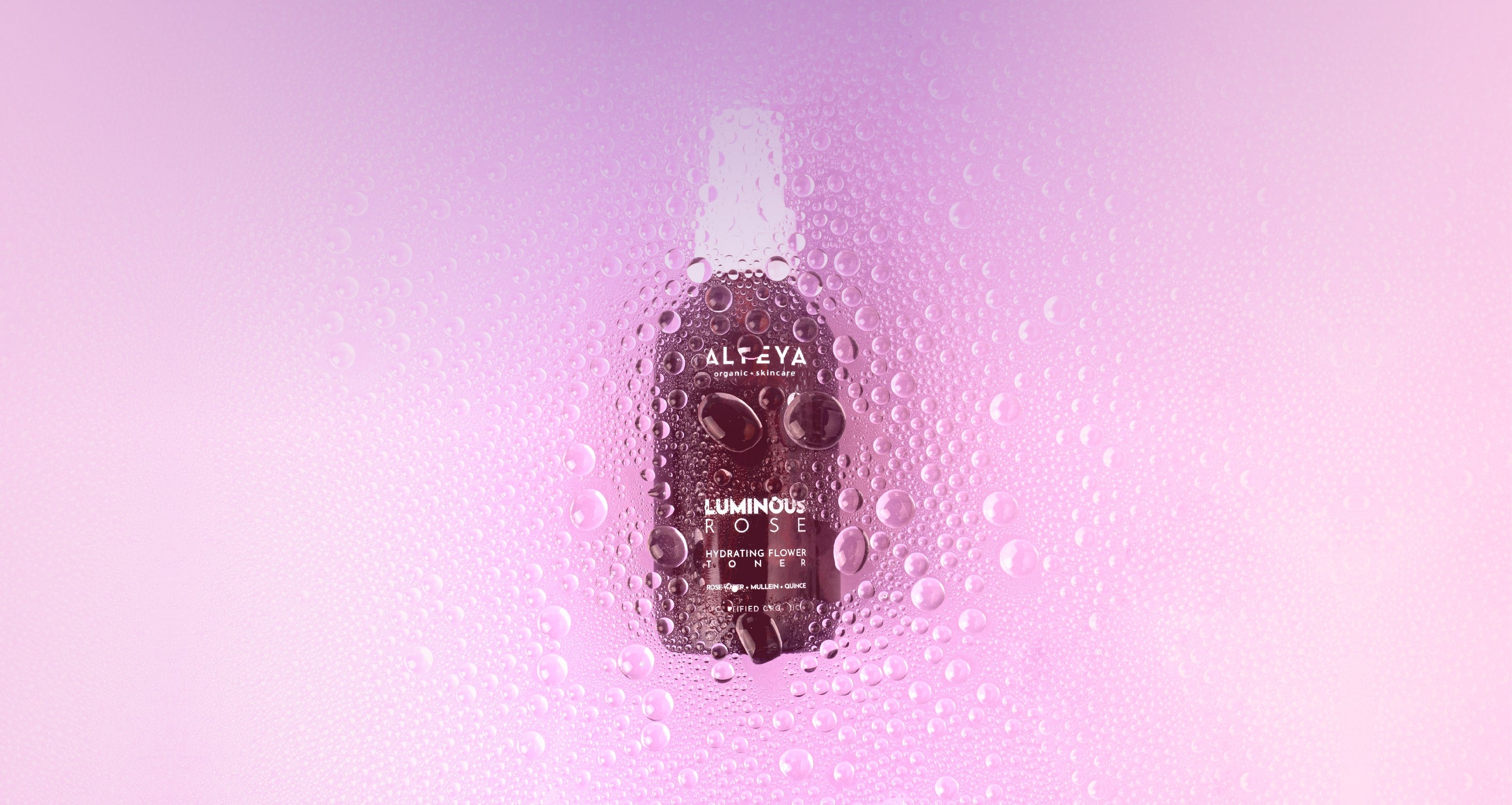A bottle of water on a pink background.
